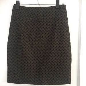 Army green and black skirt, fitted, back slit.